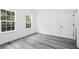Bright bedroom with ample natural light, featuring modern wood flooring and neutral walls at 162 Nw 42Nd Pl, Ocala, FL 34475