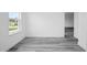 Bedroom features modern gray laminate flooring and natural light from the window at 162 Nw 42Nd Pl, Ocala, FL 34475