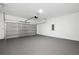 Spacious two car garage with automatic door, concrete floor and white painted walls at 162 Nw 42Nd Pl, Ocala, FL 34475