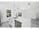 Kitchen island with stainless steel sink and dishwasher, perfect for meal prep and entertaining at 162 Nw 42Nd Pl, Ocala, FL 34475