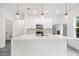 Bright kitchen boasts a large island, stainless steel appliances, and pendant lighting at 162 Nw 42Nd Pl, Ocala, FL 34475