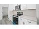 Kitchen features stainless steel appliances, white cabinets, and quartz countertops at 162 Nw 42Nd Pl, Ocala, FL 34475