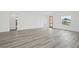 Spacious living room featuring a modern wooden door, wood-look flooring, and ample natural light at 162 Nw 42Nd Pl, Ocala, FL 34475
