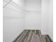 A small walk-in closet with wood-style flooring and white walls with wire shelving at 162 Nw 42Nd Pl, Ocala, FL 34475