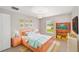 Cozy bedroom features colorful décor, a window view, and bright, natural light at 16605 Sw 31 Cir, Ocala, FL 34473