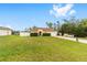 Charming yellow ranch-style home with a well-manicured front lawn and a white picket fence, creating a welcoming curb appeal at 16605 Sw 31 Cir, Ocala, FL 34473