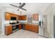 Bright kitchen showcasing stainless steel appliances, wooden cabinets, and a stylish tile backsplash at 16605 Sw 31 Cir, Ocala, FL 34473
