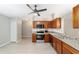 Spacious kitchen with modern appliances, wooden cabinets, and sleek tile flooring at 16605 Sw 31 Cir, Ocala, FL 34473