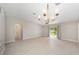 Spacious living room with tile floors, access to bathroom, and sliding glass doors to the backyard at 16605 Sw 31 Cir, Ocala, FL 34473