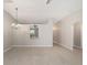 Spacious living room with tile floors, chandelier, and access to kitchen and hallway at 16605 Sw 31 Cir, Ocala, FL 34473