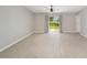 Spacious living room features wood-look floors and sliding glass doors to the backyard at 16605 Sw 31 Cir, Ocala, FL 34473
