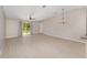 Open living area features wood-look tile floors and sliding glass doors to the backyard at 16605 Sw 31 Cir, Ocala, FL 34473
