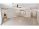 Living room with tile floors, neutral walls, and entry views of bathrooms and hallway at 16605 Sw 31 Cir, Ocala, FL 34473