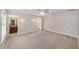 A spacious main bedroom features a ceiling fan, sconce lighting and a walk in closet at 16605 Sw 31 Cir, Ocala, FL 34473