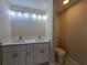 Well-lit bathroom featuring a double vanity, stylish fixtures and toilet at 20 Malauka Trail Crse, Ocklawaha, FL 32179