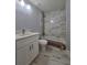 Updated bathroom with white vanity, marble countertop, and white marble-look tile at 20 Malauka Trail Crse, Ocklawaha, FL 32179