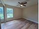 Bright bedroom featuring a ceiling fan and a large window at 20 Malauka Trail Crse, Ocklawaha, FL 32179