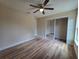 Bedroom includes ceiling fan, closet, and wood-look laminate flooring at 20 Malauka Trail Crse, Ocklawaha, FL 32179
