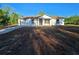 A charming single-story home featuring new construction, a brown roof, and a one-car garage at 20 Malauka Trail Crse, Ocklawaha, FL 32179