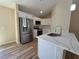 New kitchen with stainless steel refrigerator and white cabinets at 20 Malauka Trail Crse, Ocklawaha, FL 32179