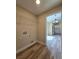 A laundry room with shelving, utility connections, and stylish wood-look flooring at 20 Malauka Trail Crse, Ocklawaha, FL 32179