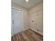 A clean laundry room with storage shelving and new wood-look floors at 20 Malauka Trail Crse, Ocklawaha, FL 32179