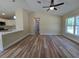 Open-concept living room with a breakfast bar and wood-look flooring at 20 Malauka Trail Crse, Ocklawaha, FL 32179