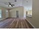 Inviting living room with wood-look floors, an open floor plan and natural light at 20 Malauka Trail Crse, Ocklawaha, FL 32179