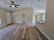 Open living space featuring wood-look laminate floors and neutral paint at 20 Malauka Trail Crse, Ocklawaha, FL 32179