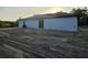 Side view of house highlighting the white exterior and back sliding glass door that leads to yard at 20 Malauka Trail Crse, Ocklawaha, FL 32179