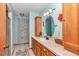 Well-lit bathroom with wooden cabinets, a countertop sink, and neutral-toned walls at 23608 Ne 124 Place Rd, Salt Springs, FL 32134