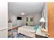 Bright bedroom with a floral rug, dresser, ceiling fan and access to the backyard at 23608 Ne 124 Place Rd, Salt Springs, FL 32134