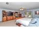 Bright primary bedroom with ceiling fan, wood furniture, and adjoining rooms at 23608 Ne 124 Place Rd, Salt Springs, FL 32134