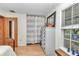 Bright bedroom featuring a large gray dresser, wood floors and metal frame bed at 23608 Ne 124 Place Rd, Salt Springs, FL 32134