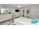 Light bedroom with a floral rug, dresser, ceiling fan and access to the backyard at 23608 Ne 124 Place Rd, Salt Springs, FL 32134