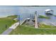 Beautiful view of a dock with boats, providing direct access to the serene lake at 23608 Ne 124 Place Rd, Salt Springs, FL 32134