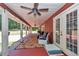 Long covered porch with rocking chairs and views of the landscaped yard at 23608 Ne 124 Place Rd, Salt Springs, FL 32134