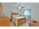 Cozy bedroom featuring a ceiling fan, a comfortable bed, and a window with patterned curtains at 2478 Nw 50Th Ave, Ocala, FL 34482