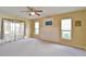 Spacious bedroom featuring a ceiling fan, two windows and neutral colored walls and carpet at 2478 Nw 50Th Ave, Ocala, FL 34482