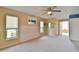 The bedroom is spacious with neutral walls, carpet, ceiling fan, plus views to an entryway at 2478 Nw 50Th Ave, Ocala, FL 34482