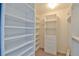 Bright walk-in closet features built-in shelves and drawers providing ample storage space at 2478 Nw 50Th Ave, Ocala, FL 34482