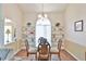 Cozy dining room featuring a glass table, built-in shelving, and an arched window creating a warm atmosphere at 2478 Nw 50Th Ave, Ocala, FL 34482