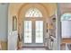 Grand entryway showcasing beautiful double doors, transom window and arched ceiling for an inviting welcome at 2478 Nw 50Th Ave, Ocala, FL 34482