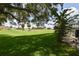 Lush green backyard adjacent to the golf course provides a serene and picturesque setting at 2478 Nw 50Th Ave, Ocala, FL 34482