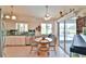 Bright kitchen with a dining area, tile floors, and sliding doors that lead to a screened-in porch and pool at 2478 Nw 50Th Ave, Ocala, FL 34482
