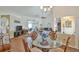 Open-concept living and dining area with tiled floors, views of the screened-in porch, and lots of natural light at 2478 Nw 50Th Ave, Ocala, FL 34482