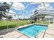Enclosed pool with sunny views of the golf course, complete with convenient grab bars and brick pavers at 2478 Nw 50Th Ave, Ocala, FL 34482