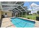 View of screened-in pool area with pavers, steel grab bar, and exterior access; ready for outdoor enjoyment at 2478 Nw 50Th Ave, Ocala, FL 34482