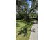 Spacious front yard featuring a large tree providing shade and an inviting driveway at 2927 Se 13Th St, Ocala, FL 34471