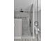 Modern bathroom featuring walk-in shower with rainfall shower head and glass door at 3696 Se 139Th Ln, Summerfield, FL 34491